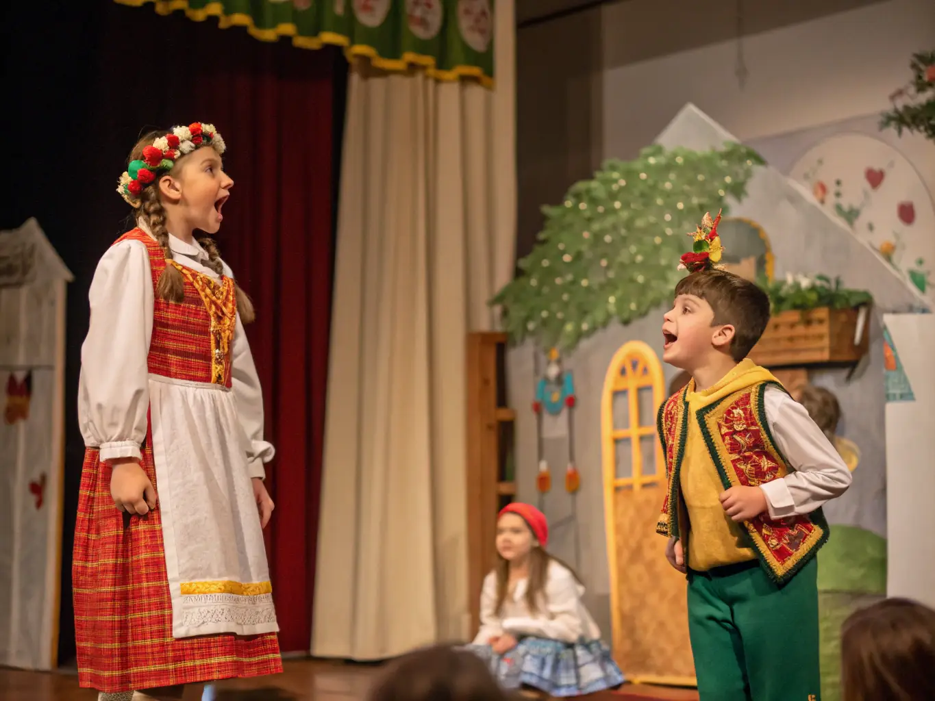 A photograph of children performing a theatrical play on a small stage, with colorful costumes and expressive gestures. The image conveys the joy and confidence gained through participation in performing arts.